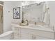 Bright bathroom with a marble countertop, white cabinets, and golden hardware at 75 14Th Ne St # 3820, Atlanta, GA 30309