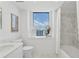 Bright bathroom with a marble vanity, white tile, and a picturesque city view at 75 14Th Ne St # 3820, Atlanta, GA 30309