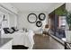 Bright bedroom featuring hardwood floors, stylish decor, and a sliding glass door to a balcony at 75 14Th Ne St # 3820, Atlanta, GA 30309