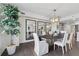 Open-concept dining area showcasing modern chandelier, hardwood floors and a large indoor plant at 75 14Th Ne St # 3820, Atlanta, GA 30309