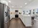 Spacious kitchen with stainless steel appliances, white cabinets, marble counters and breakfast bar seating at 75 14Th Ne St # 3820, Atlanta, GA 30309