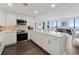 Well-lit kitchen featuring white cabinets, marble countertops, stainless appliances, and eat-in bar at 75 14Th Ne St # 3820, Atlanta, GA 30309