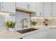 Close-up of modern kitchen sink with marble backsplash, elegant faucet, and decorative accents at 75 14Th Ne St # 3820, Atlanta, GA 30309