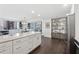Open-concept kitchen with white cabinets, marble countertops, stainless steel appliances, and breakfast bar at 75 14Th Ne St # 3820, Atlanta, GA 30309
