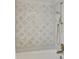 Elegant shower featuring intricate marble tile work and gold-toned fixtures at 75 14Th Ne St # 3820, Atlanta, GA 30309