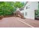 Spacious deck with stairs, attached to the rear of the house and overlooking a wooded yard at 835 Timber Lake Trl, Cumming, GA 30041