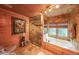 Beautiful bathroom with stone shower, stone tub and walls, and tile floors at 835 Timber Lake Trl, Cumming, GA 30041