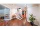 Inviting entryway with hardwood floors, white trim, and a view of a den and staircase at 835 Timber Lake Trl, Cumming, GA 30041