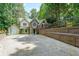 Charming home featuring unique stone accents, a spacious driveway, and lush greenery at 835 Timber Lake Trl, Cumming, GA 30041
