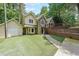 Charming home featuring unique stone accents, a spacious driveway, and lush greenery at 835 Timber Lake Trl, Cumming, GA 30041