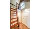 Hallway with unique design elements including a wooden ladder and a decorative window at 835 Timber Lake Trl, Cumming, GA 30041
