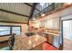 Well-equipped kitchen with granite countertops, stainless steel appliances, and open shelving at 835 Timber Lake Trl, Cumming, GA 30041