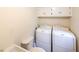 Practical laundry room with a utility sink, toilet, and appliances for added convenience at 835 Timber Lake Trl, Cumming, GA 30041