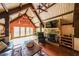 Inviting living room showcasing hardwood floors, stone fireplace, and vaulted wood-paneled ceiling at 835 Timber Lake Trl, Cumming, GA 30041
