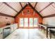 Open living space with kitchenette, stone counters, and french doors leading to balcony at 835 Timber Lake Trl, Cumming, GA 30041