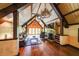 Cozy living room with a fireplace, beamed ceilings, and comfortable seating at 835 Timber Lake Trl, Cumming, GA 30041