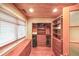 Walk-in closet with custom built-in shelving and drawers, complete with a window at 835 Timber Lake Trl, Cumming, GA 30041