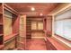 Bright walk-in closet with wooden floors, recessed lighting and custom shelving at 835 Timber Lake Trl, Cumming, GA 30041