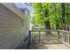 Exterior view of a wooden deck surrounded by trees in the backyard at 3110 Ashly Cove Ln, Snellville, GA 30078