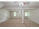 Open basement area with plush carpeting, neutral paint and natural light from two windows at 3110 Ashly Cove Ln, Snellville, GA 30078