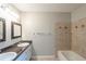 Bright bathroom featuring double sink vanity, stylish framed mirrors and tiled shower at 3110 Ashly Cove Ln, Snellville, GA 30078