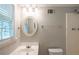 Bright bathroom featuring natural light, a vanity, and a toilet at 3110 Ashly Cove Ln, Snellville, GA 30078