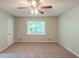 Large carpeted bedroom with a ceiling fan and natural light from a window at 3110 Ashly Cove Ln, Snellville, GA 30078