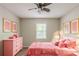 Bright bedroom featuring a cozy pink bed, a ceiling fan, lots of natural light, and decorative wall art at 3110 Ashly Cove Ln, Snellville, GA 30078