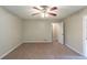 Spacious carpeted bedroom featuring a ceiling fan, natural light, and closet at 3110 Ashly Cove Ln, Snellville, GA 30078