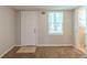 Bedroom featuring carpet, a window for natural light, and an entry door at 3110 Ashly Cove Ln, Snellville, GA 30078