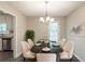 Formal dining room featuring a marble table with seating for six, a stylish chandelier, and access to kitchen at 3110 Ashly Cove Ln, Snellville, GA 30078