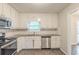 Bright kitchen with white cabinets, stainless steel appliances, and tile flooring at 3110 Ashly Cove Ln, Snellville, GA 30078