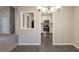 View from the dining room into a well-appointed kitchen with white cabinets and stainless steel appliances at 3110 Ashly Cove Ln, Snellville, GA 30078