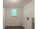 Functional laundry room with tile floors and a bright window, offering space for appliances at 3110 Ashly Cove Ln, Snellville, GA 30078