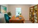 Functional home office with built-in bookshelves, a large wooden desk, and lots of natural light at 3110 Ashly Cove Ln, Snellville, GA 30078