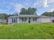 Charming single-story home featuring a covered front porch and attached two-car garage at 563 Fieldgreen Dr, Jonesboro, GA 30238