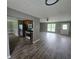 Open-concept living room and kitchen with hardwood floors and stainless steel appliances at 563 Fieldgreen Dr, Jonesboro, GA 30238