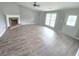 Open-concept living room features a fireplace, large windows, and light wood floors at 563 Fieldgreen Dr, Jonesboro, GA 30238