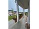 Inviting covered front porch with classic white columns and a view of the landscaped yard at 1654 Tide Mill Rd, Cumming, GA 30040