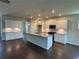 Bright kitchen featuring stainless appliances, granite countertops and a large center island at 1654 Tide Mill Rd, Cumming, GA 30040