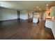 Open-concept living room with dark wood floors flowing into a gourmet kitchen with island and stainless appliances at 1654 Tide Mill Rd, Cumming, GA 30040
