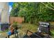 Outdoor space features a grill, landscaping, lighting and wooden fence at 183 Venture Path, Hiram, GA 30141