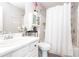Clean bathroom features white shower curtain, vanity, and decorative floral accents at 183 Venture Path, Hiram, GA 30141
