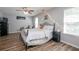 Bright bedroom featuring wood floors, ceiling fan, and black metal bed frame at 183 Venture Path, Hiram, GA 30141