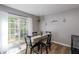 Cozy dining area with wood-look floors and sliding glass door with lots of natural light at 183 Venture Path, Hiram, GA 30141