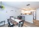 Open concept dining area with view into the kitchen with white cabinets and stainless appliances at 183 Venture Path, Hiram, GA 30141