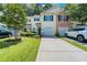Charming townhome with a well-manicured front yard, driveway, and attached garage at 183 Venture Path, Hiram, GA 30141