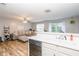 Open layout of kitchen and living room with stainless steel appliances and wood flooring at 183 Venture Path, Hiram, GA 30141