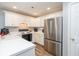 Bright kitchen featuring white cabinetry, stainless steel appliances, and solid countertops at 183 Venture Path, Hiram, GA 30141