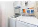 Laundry area with a modern washer and dryer, shelf and storage basket at 183 Venture Path, Hiram, GA 30141
